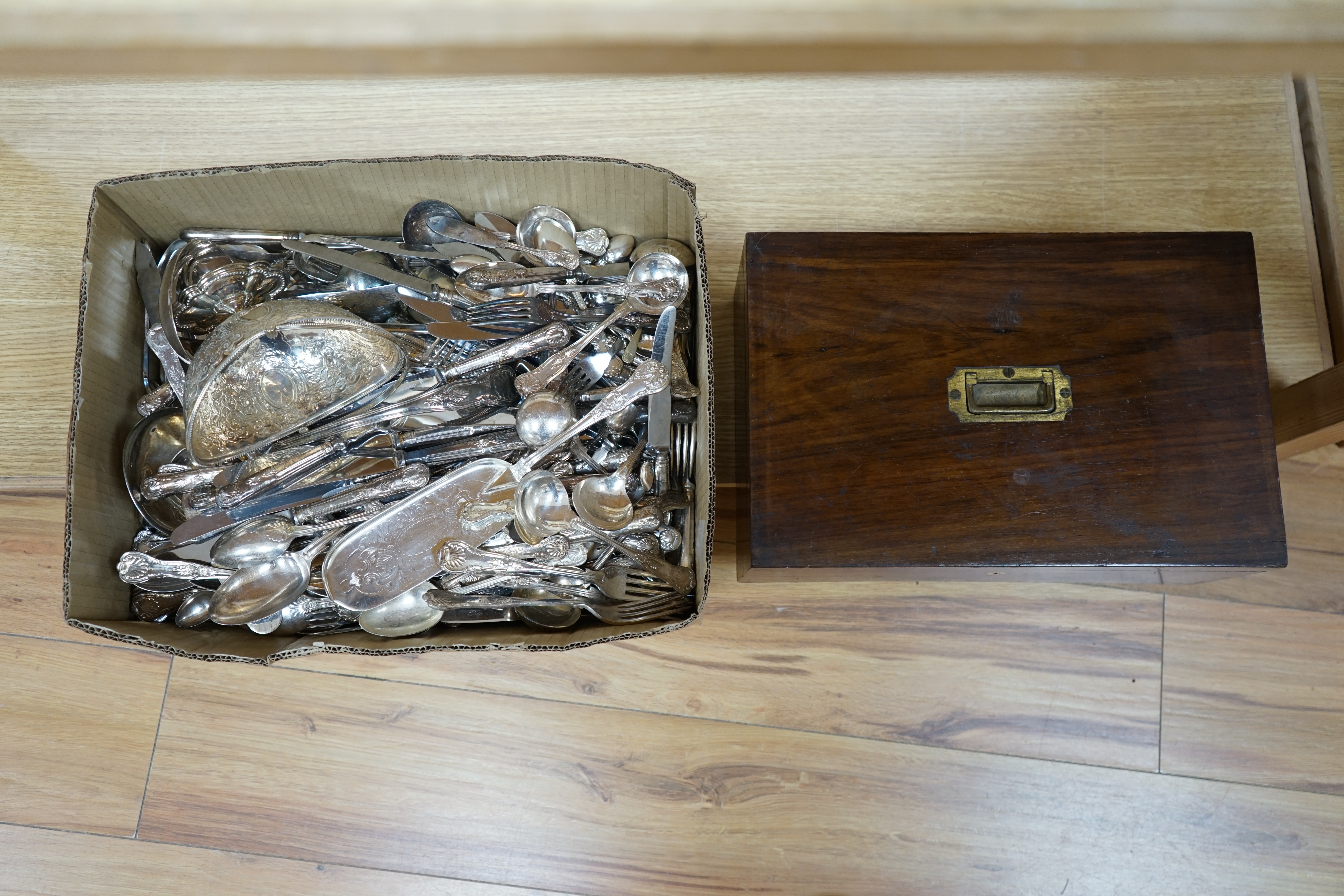 A large quantity silver plated cutlery including a part canteen of King's pattern cutlery and beaded pattern cutlery, a plated sugar basket, together with a mahogany, velvet lined box, 38cm wide. Condition - fair